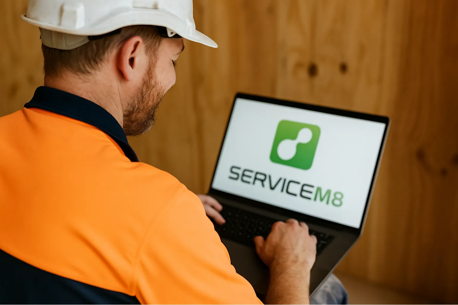 Tradie running ServiceM8 on a laptop on site